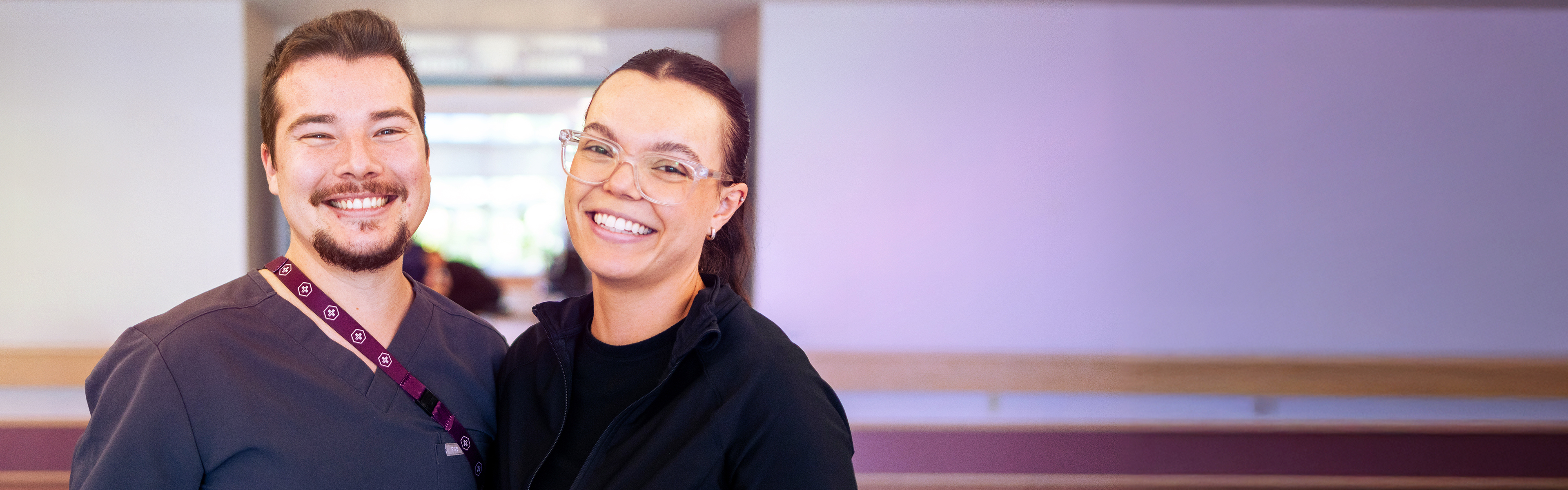 two staff standing together